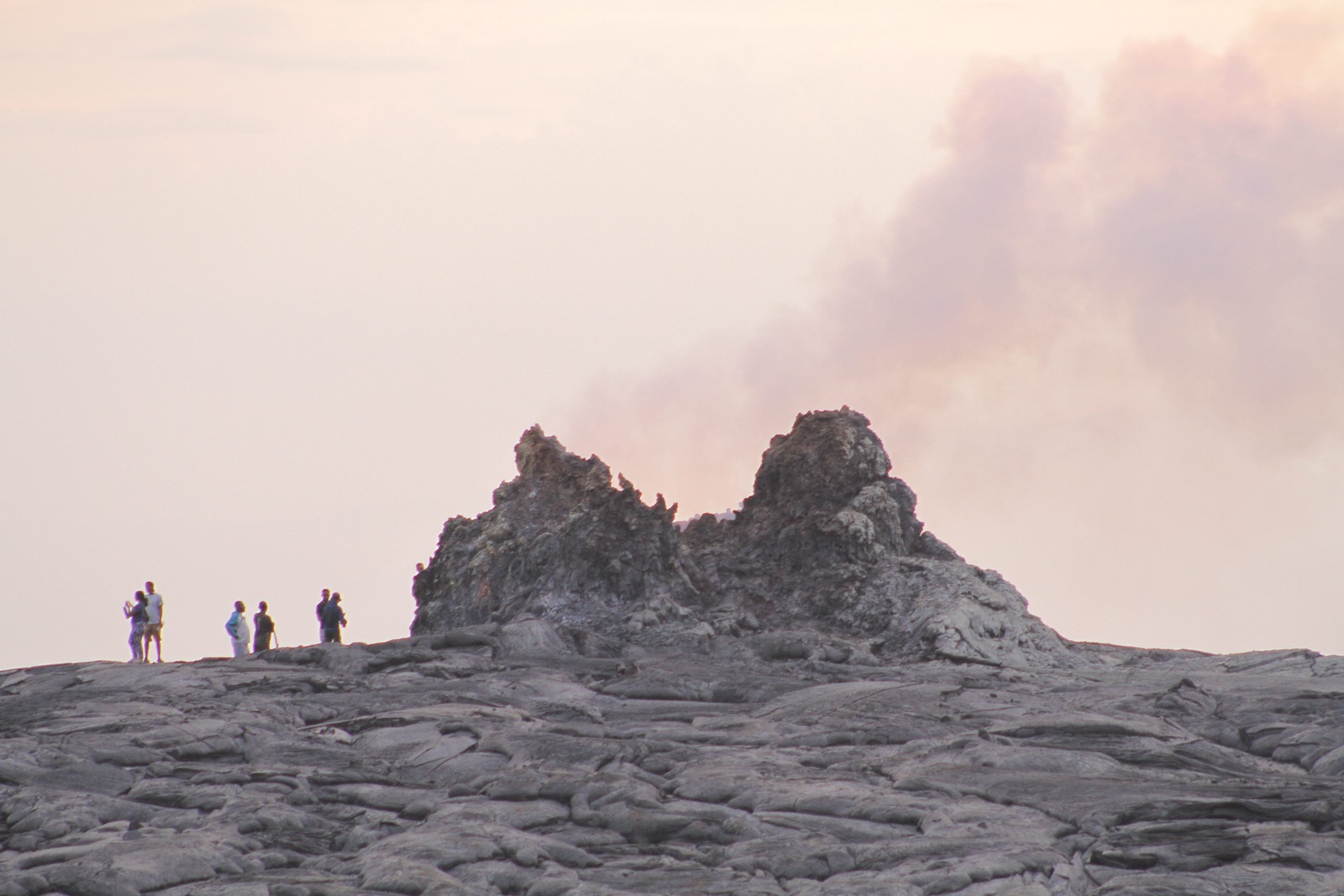 Figures exploring a steaming volcanic formation in Afar