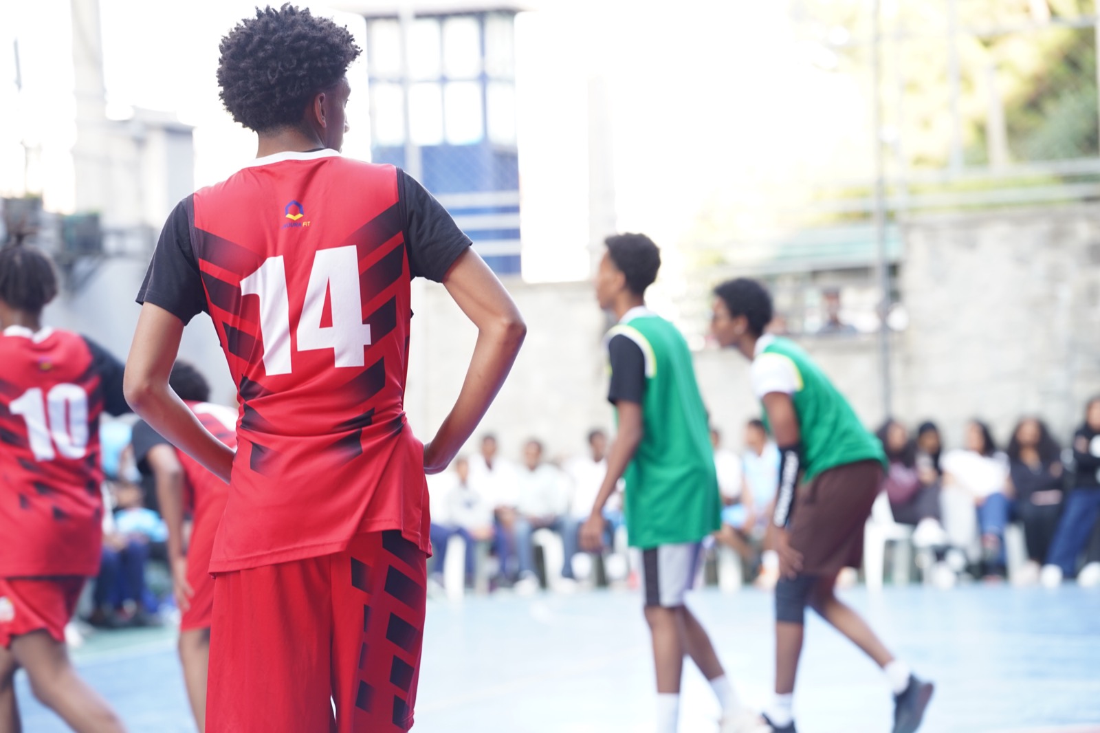 Youth basketball team huddling during a Carlos Thornton program