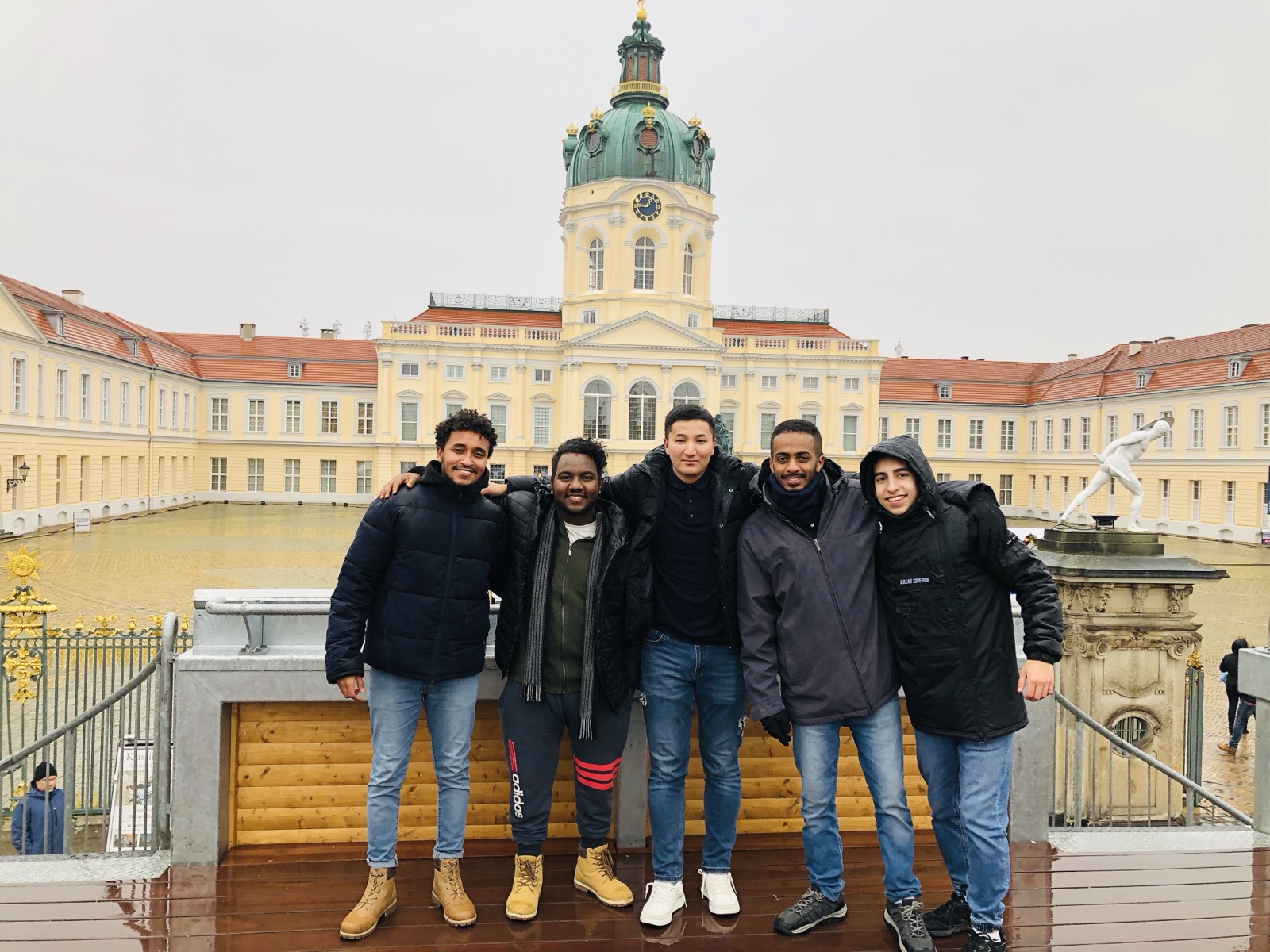 Multicultural outreach team together on a bridge in Berlin
